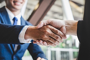 the owner of a manufacturing company shaking hands with a business mapping expert