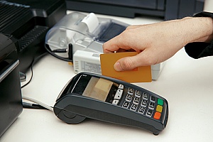 cashier swiping a credit card during a sale at a retail store